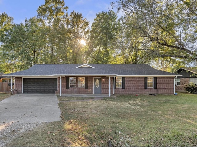 ranch-style home with a garage and a front lawn