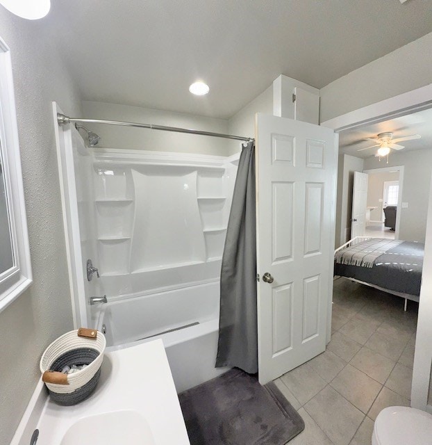 bathroom featuring tile patterned flooring, toilet, shower / bath combination with curtain, and ceiling fan