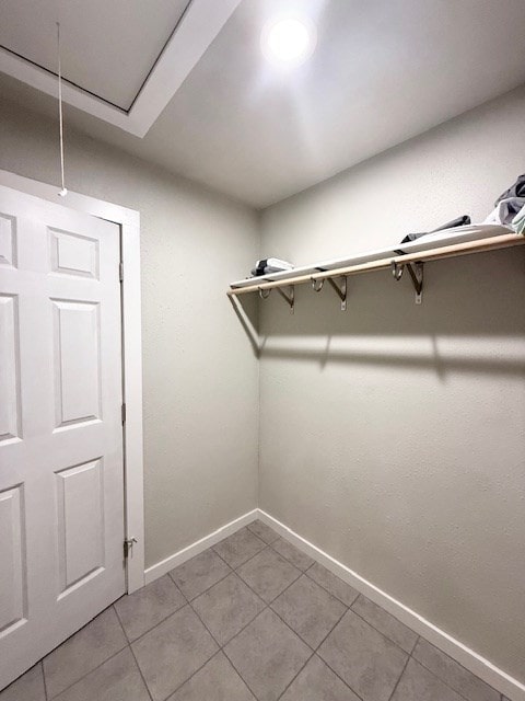 walk in closet featuring light tile patterned flooring