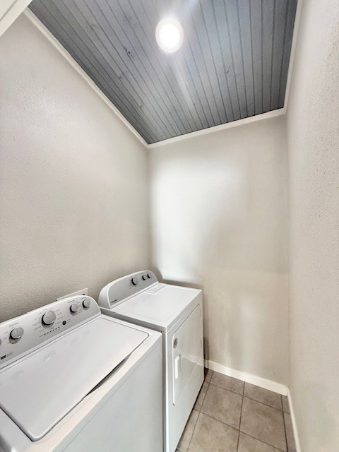 washroom featuring light tile patterned floors and washer and clothes dryer