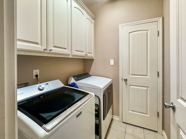 washroom featuring cabinets, light tile patterned flooring, and independent washer and dryer