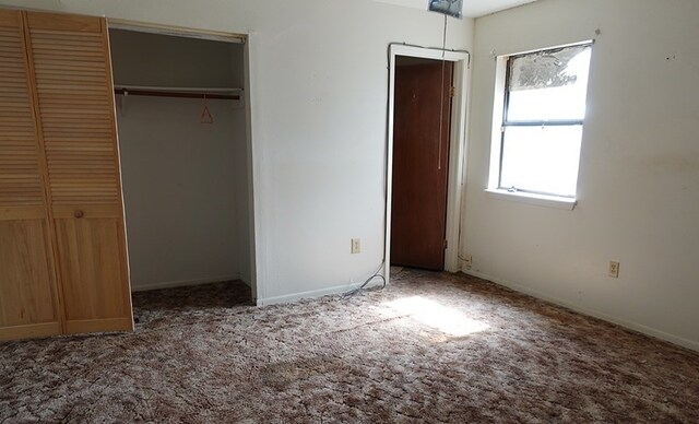 718 Pinewood, Diboll, TX 75941 - unfurnished bedroom featuring carpet and two closets