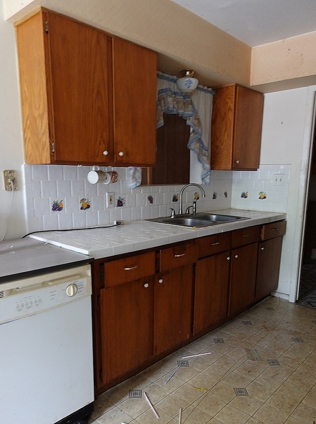 718 Pinewood, Diboll, TX 75941 - kitchen featuring white dishwasher, tile countertops, backsplash, and brown cabinets