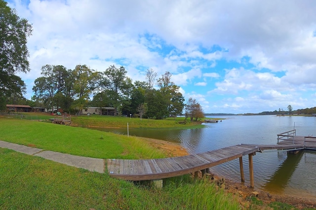 dock area featuring a lawn and a water view