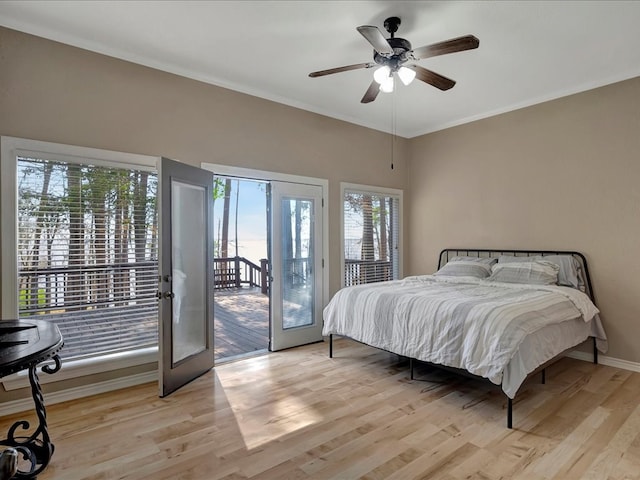 bedroom with ceiling fan, light hardwood / wood-style floors, access to outside, and multiple windows