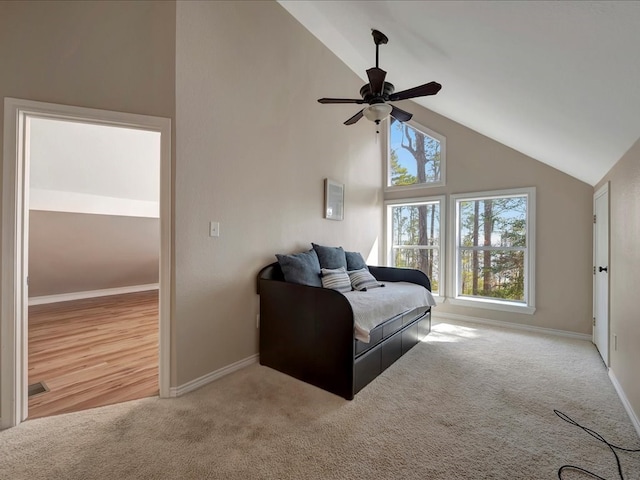 carpeted bedroom with high vaulted ceiling and ceiling fan