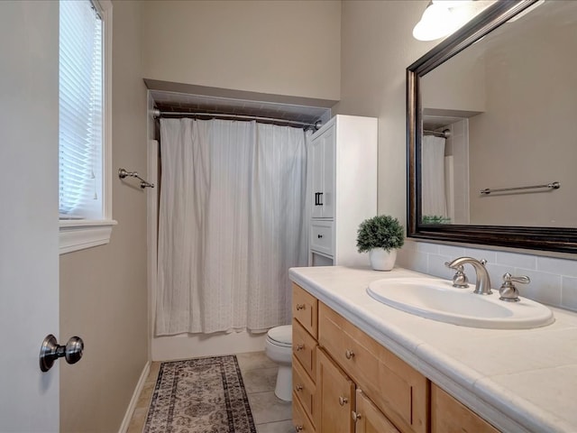 full bathroom featuring tile patterned flooring, decorative backsplash, toilet, and a wealth of natural light