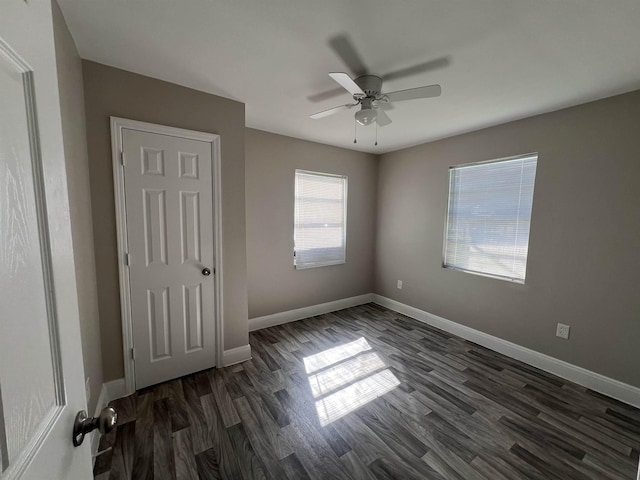 unfurnished bedroom featuring dark hardwood / wood-style floors and ceiling fan