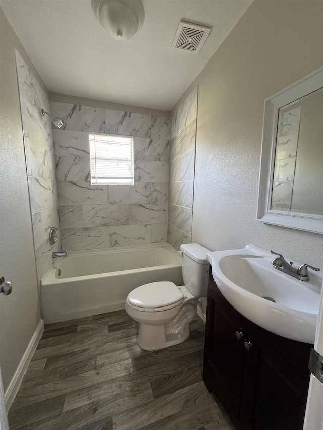 full bathroom with toilet, vanity, tiled shower / bath combo, and hardwood / wood-style flooring