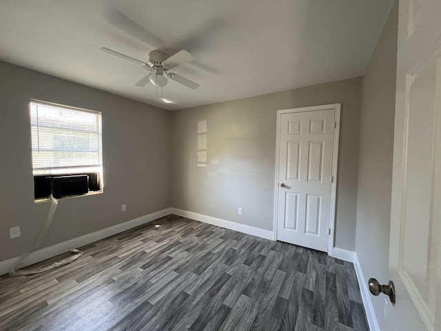 unfurnished room featuring ceiling fan, cooling unit, and dark wood-type flooring