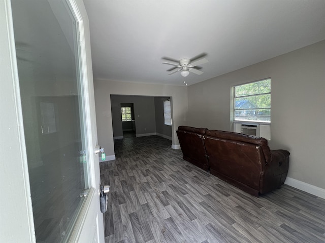 living room with hardwood / wood-style flooring, ceiling fan, and cooling unit