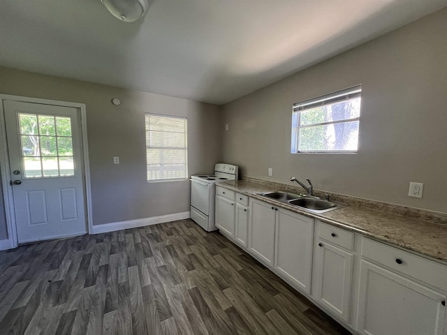 kitchen featuring white cabinets, sink, electric range, dark hardwood / wood-style floors, and washer / clothes dryer