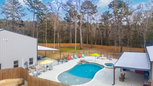 view of pool with a patio, a pool with connected hot tub, and a fenced backyard