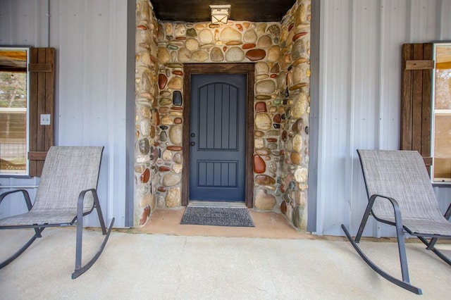 property entrance with stone siding