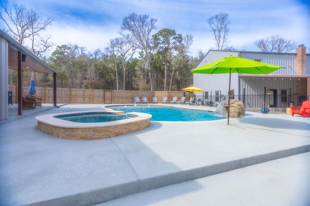 view of pool featuring a pool with connected hot tub, a patio area, and a fenced backyard