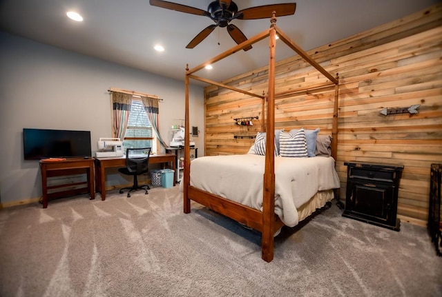 carpeted bedroom featuring recessed lighting and wood walls