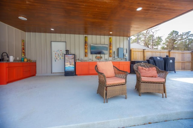 view of patio / terrace featuring electric panel, fence, and grilling area