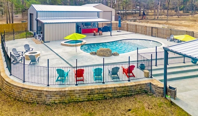 view of pool featuring a patio, a fenced backyard, an outdoor fire pit, a fenced in pool, and an in ground hot tub