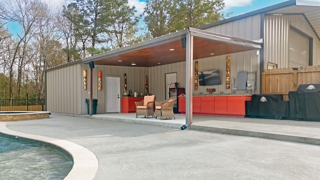 exterior space with a hot tub and fence