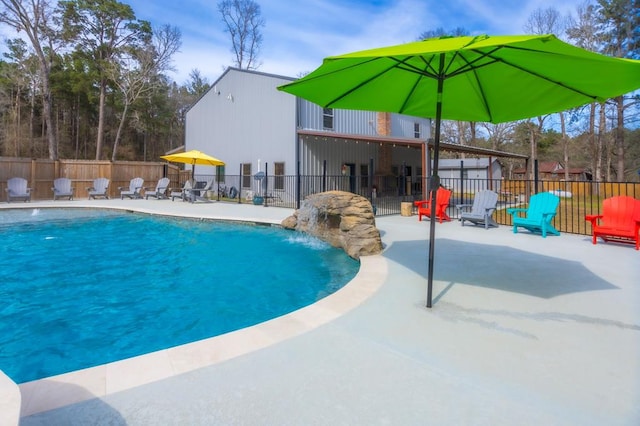 view of pool featuring a fenced in pool, fence, and a patio area