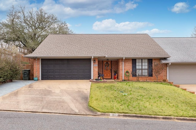 ranch-style house featuring a garage and a front lawn