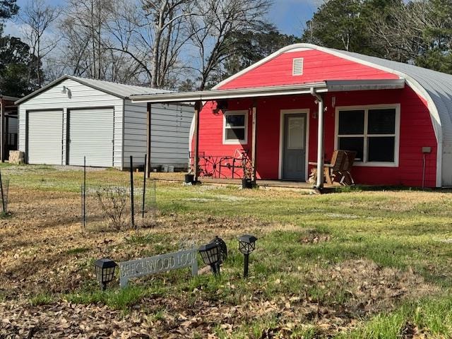 view of outbuilding featuring a garage and a lawn