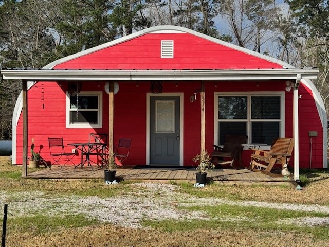 view of outdoor structure with covered porch