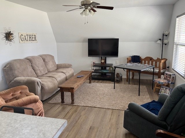 living room with lofted ceiling, wood-type flooring, and ceiling fan