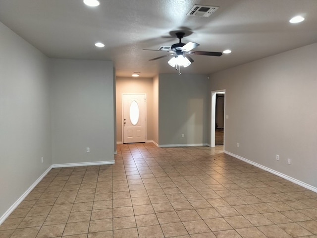 unfurnished room featuring ceiling fan and light tile patterned floors