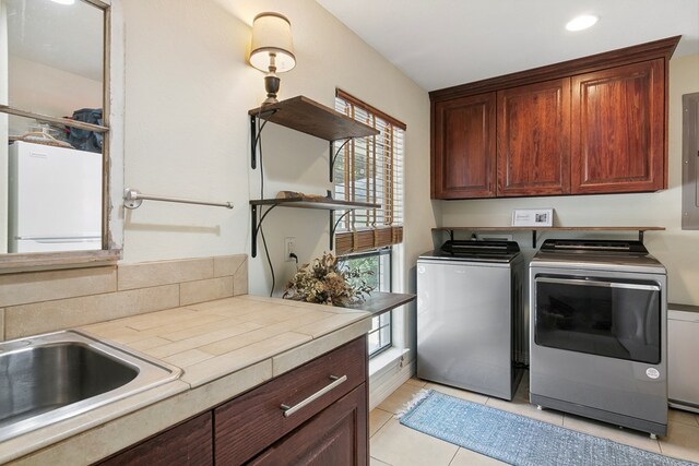 1025 Creek Bend Dr, Jasper, TX 75951 - laundry room featuring cabinet space, washer and clothes dryer, light tile patterned floors, and recessed lighting