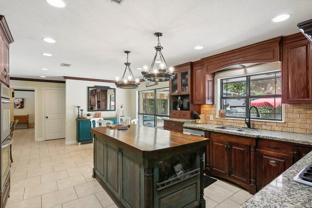 1025 Creek Bend Dr, Jasper, TX 75951 - kitchen featuring wooden counters, a chandelier, backsplash, recessed lighting, and a kitchen island