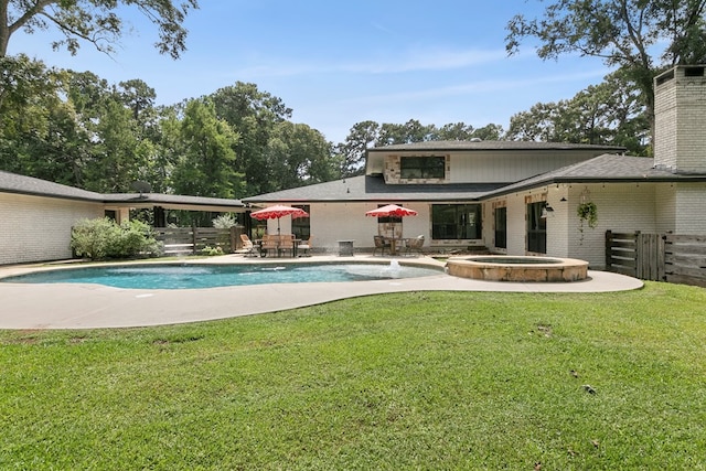 1025 Creek Bend Dr, Jasper, TX 75951 - back of house featuring a chimney, brick siding, a patio area, and a pool with connected hot tub