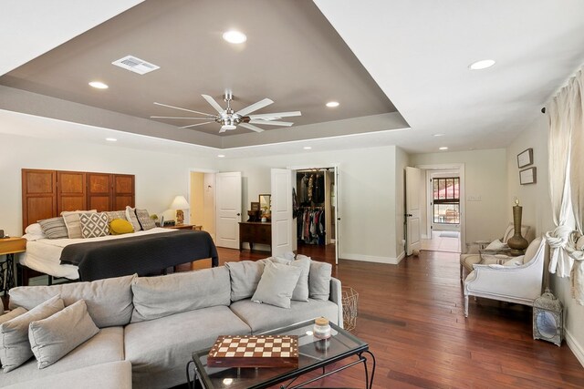 1025 Creek Bend Dr, Jasper, TX 75951 - bedroom with a tray ceiling, recessed lighting, a closet, dark wood-style flooring, and a walk in closet