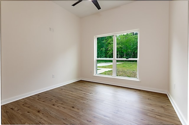 spare room featuring hardwood / wood-style floors and ceiling fan