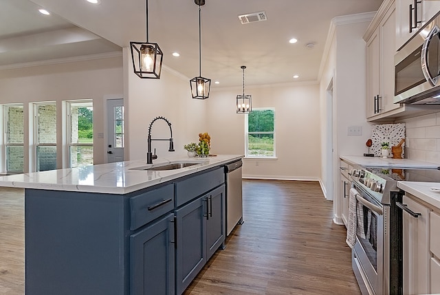 kitchen with white cabinets, a healthy amount of sunlight, sink, and stainless steel appliances