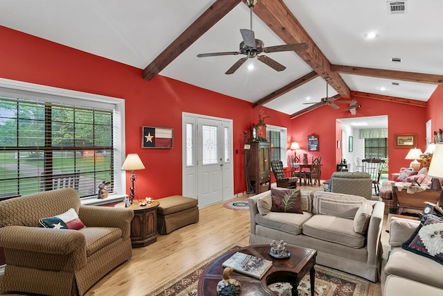 living room with vaulted ceiling with beams, light hardwood / wood-style flooring, and ceiling fan