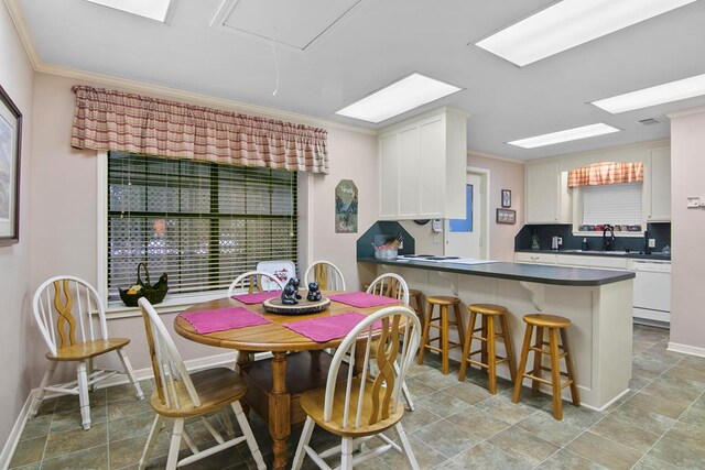 dining room featuring crown molding and sink