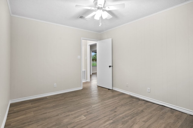 spare room with a textured ceiling, ornamental molding, dark hardwood / wood-style floors, and ceiling fan