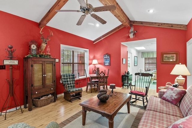 living room featuring lofted ceiling with beams, ceiling fan, and light hardwood / wood-style floors