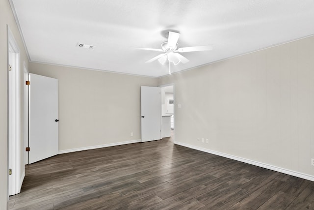 empty room featuring ornamental molding, dark hardwood / wood-style floors, and ceiling fan