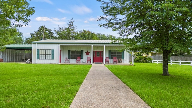 view of front facade with a front lawn, a carport, and a porch