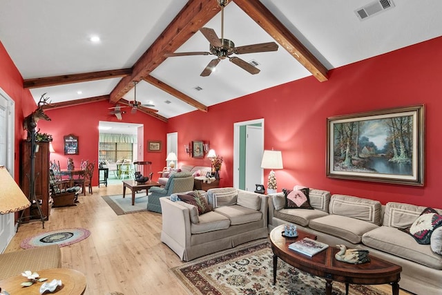 living room featuring lofted ceiling with beams, ceiling fan, and light hardwood / wood-style floors