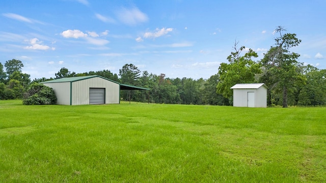 view of yard with a storage shed and a garage