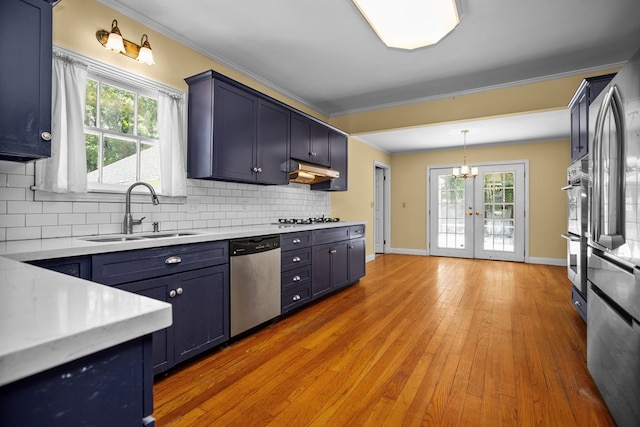 715 Pine Tree Ln, Lufkin, TX 75904 - kitchen featuring stainless steel appliances, a sink, crown molding, light countertops, and french doors
