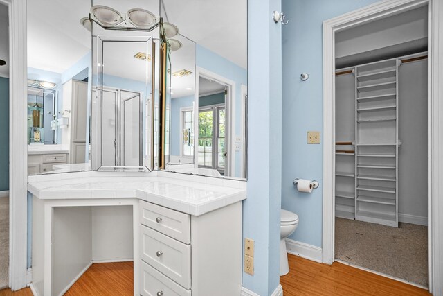 715 Pine Tree Ln, Lufkin, TX 75904 - full bathroom with a spacious closet, wood finished floors, and toilet