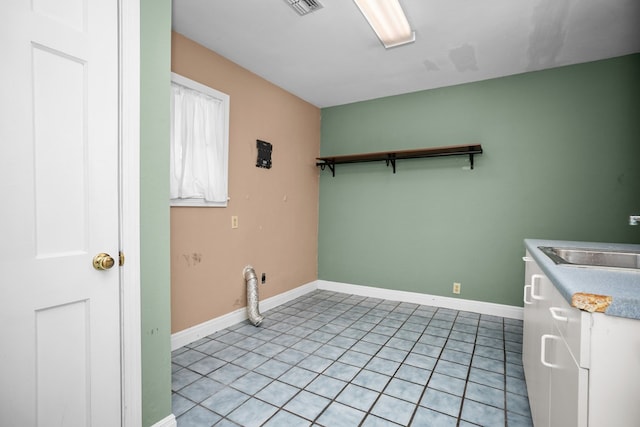 715 Pine Tree Ln, Lufkin, TX 75904 - laundry area with baseboards and light tile patterned floors