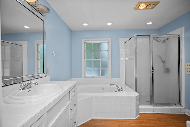 715 Pine Tree Ln, Lufkin, TX 75904 - bathroom with vanity, a bath, a shower stall, wood finished floors, and recessed lighting