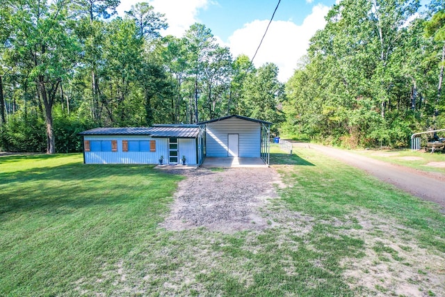 view of front of property with a front yard and a carport