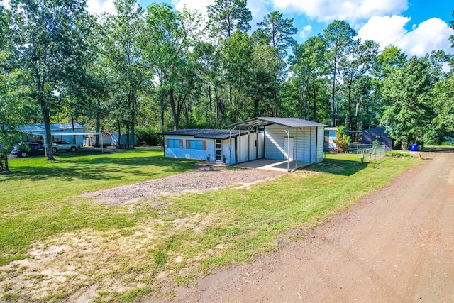 view of outbuilding featuring a yard and a carport