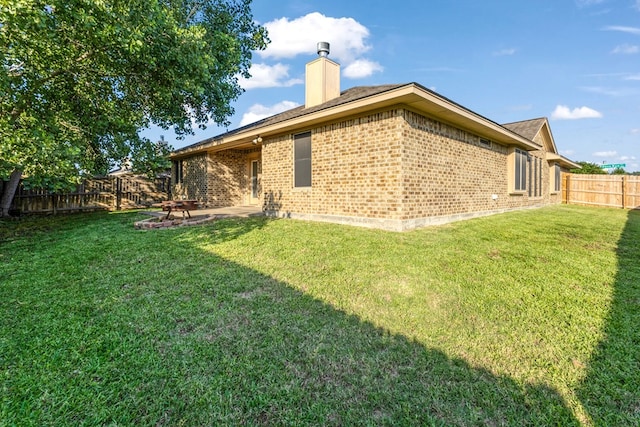 801 Dove Run Trl, College Station, TX 77845 - rear view of property with brick siding, a fenced backyard, a chimney, and a patio area